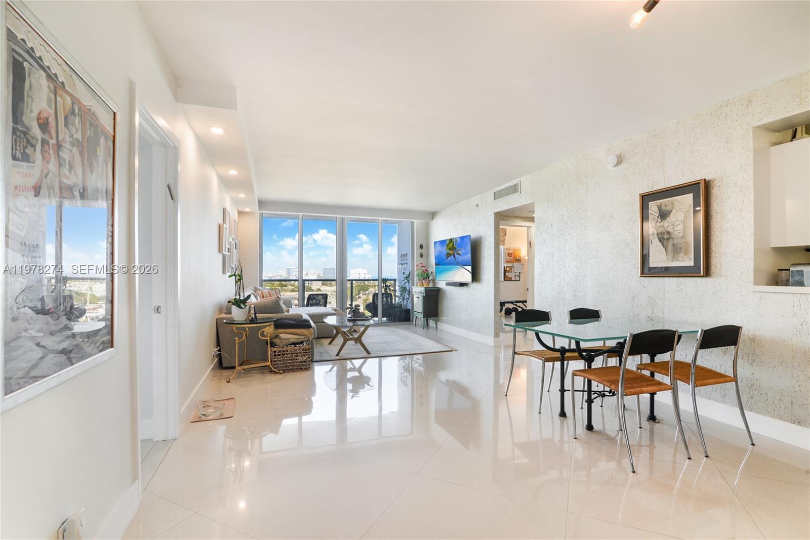 401 69th Street, Unit 913 Miami Beach, FL 33141 - Photo 5 of 26 a living room with furniture and a large window
