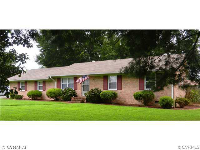 7320 Hopkins Road North Chesterfield, VA 23237 - Photo 1 of 13 a front view of a house with a garden