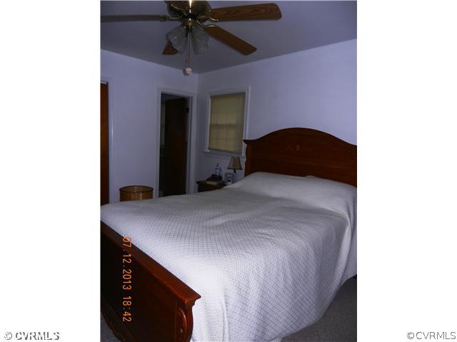 7320 Hopkins Road North Chesterfield, VA 23237 - Photo 8 of 13 a bedroom with a bed and a chandelier