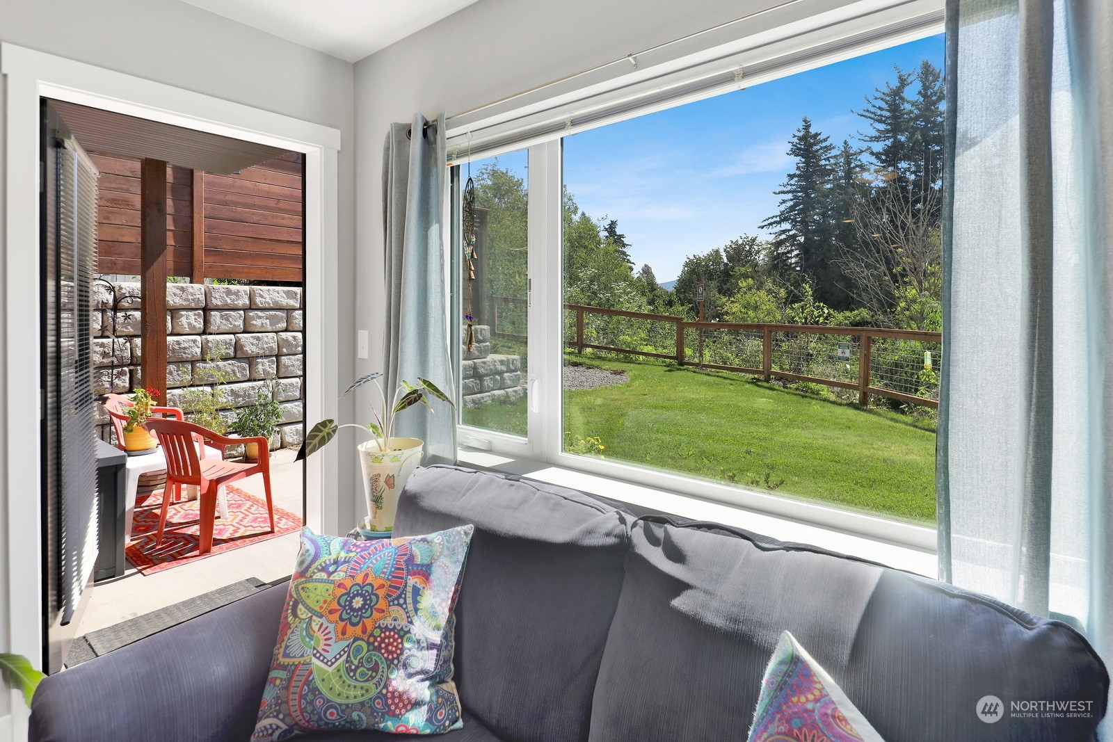 1882 Front Street, Unit 111 Lynden, WA 98264 - Photo 23 of 29 a living room with couch and a floor to ceiling window