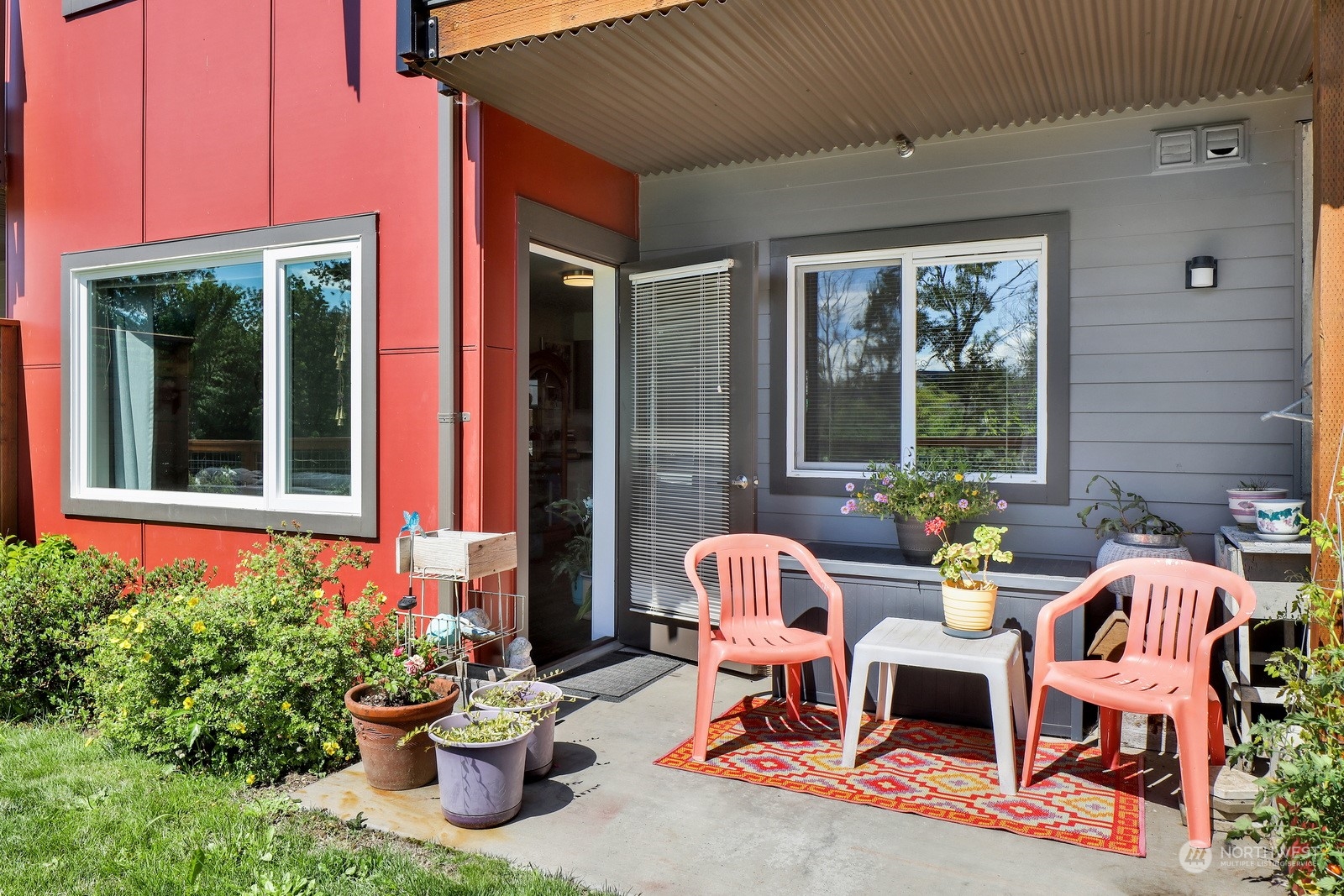 1882 Front Street, Unit 111 Lynden, WA 98264 - Photo 24 of 29 a view of a patio with couple chairs and flower plants