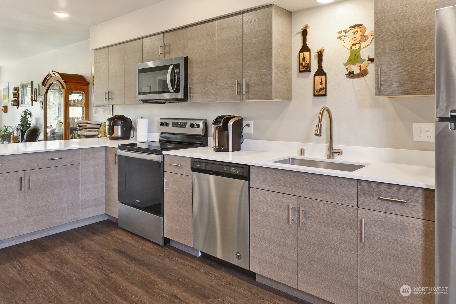 1882 Front Street, Unit 111 Lynden, WA 98264 - Photo 7 of 29 a kitchen with stainless steel appliances granite countertop a sink cabinets and wooden floor