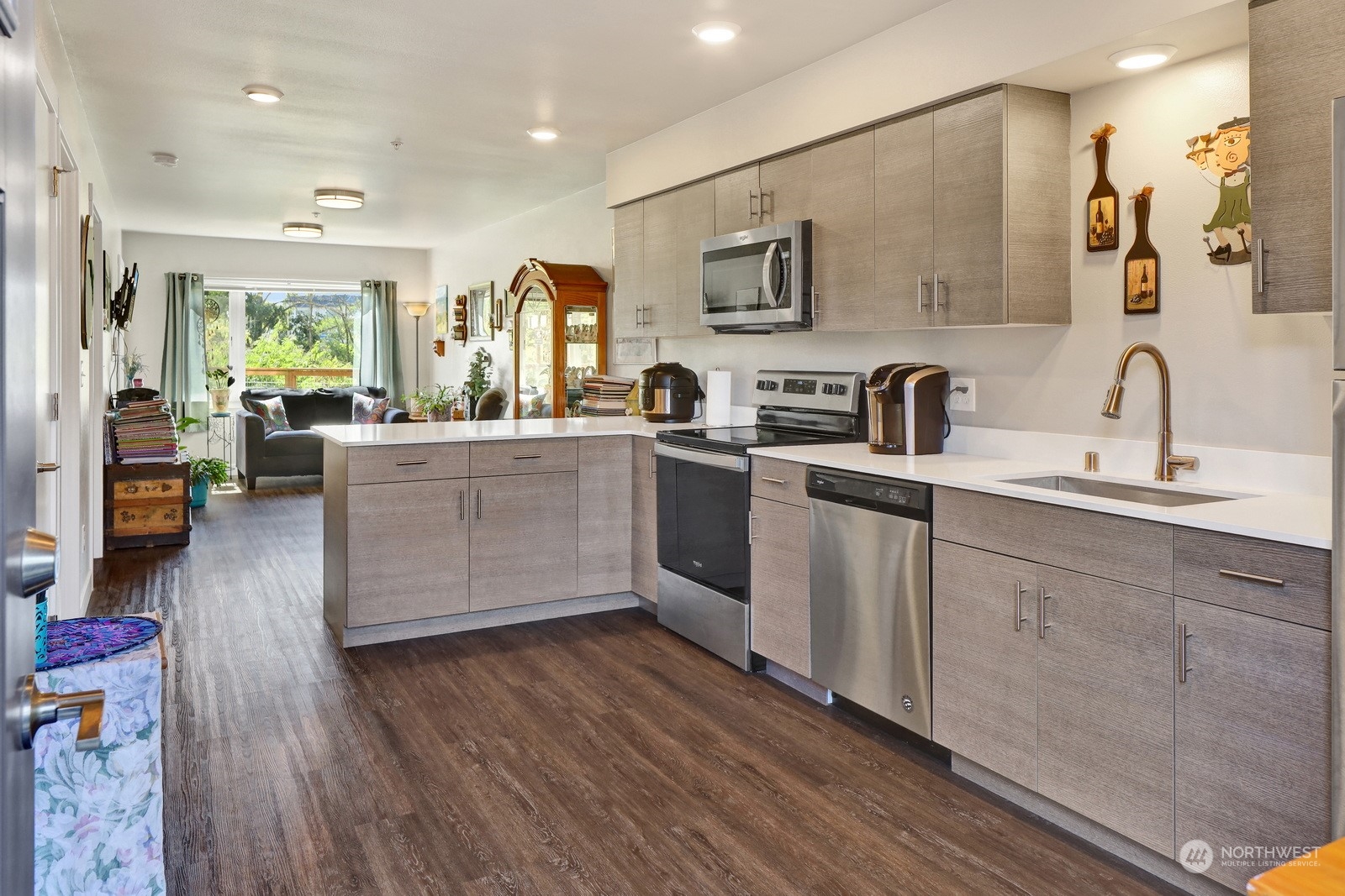 1882 Front Street, Unit 111 Lynden, WA 98264 - Photo 8 of 29 a kitchen with stainless steel appliances granite countertop wooden cabinets a sink a stove a dining table and chairs