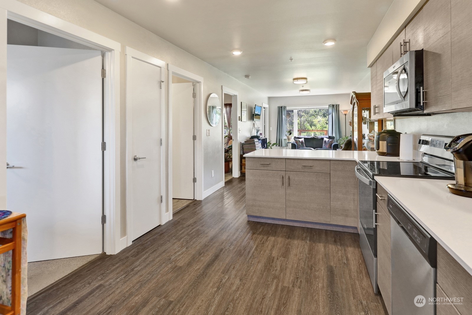 1882 Front Street, Unit 111 Lynden, WA 98264 - Photo 9 of 29 a large kitchen with a lot of counter space and wooden floor