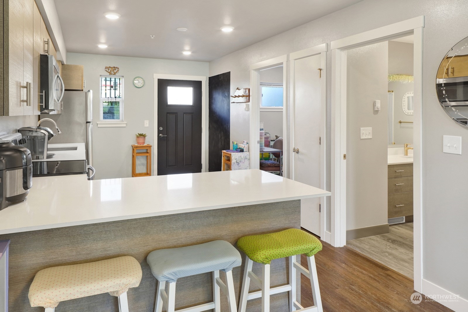 1882 Front Street, Unit 111 Lynden, WA 98264 - Photo 10 of 29 a kitchen with stainless steel appliances a dining table chairs refrigerator and sink