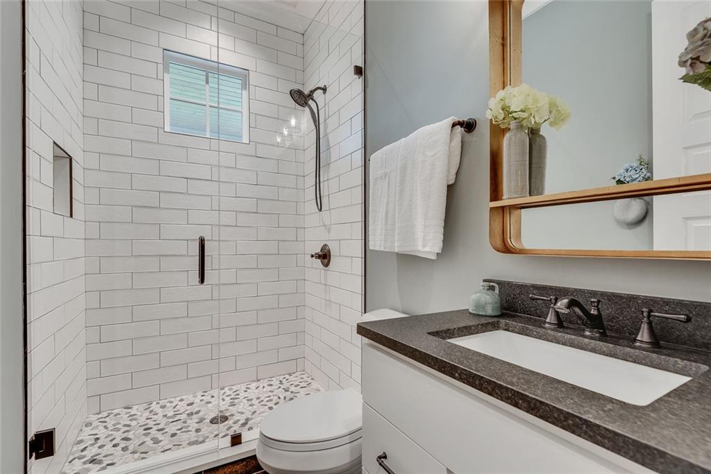 2503 Sugar Pike Road Canton, GA 30115 - Photo 85 of 134 a bathroom with a granite countertop sink a toilet and shower