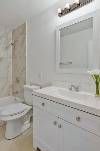 a bathroom with a sink a toilet and a mirror