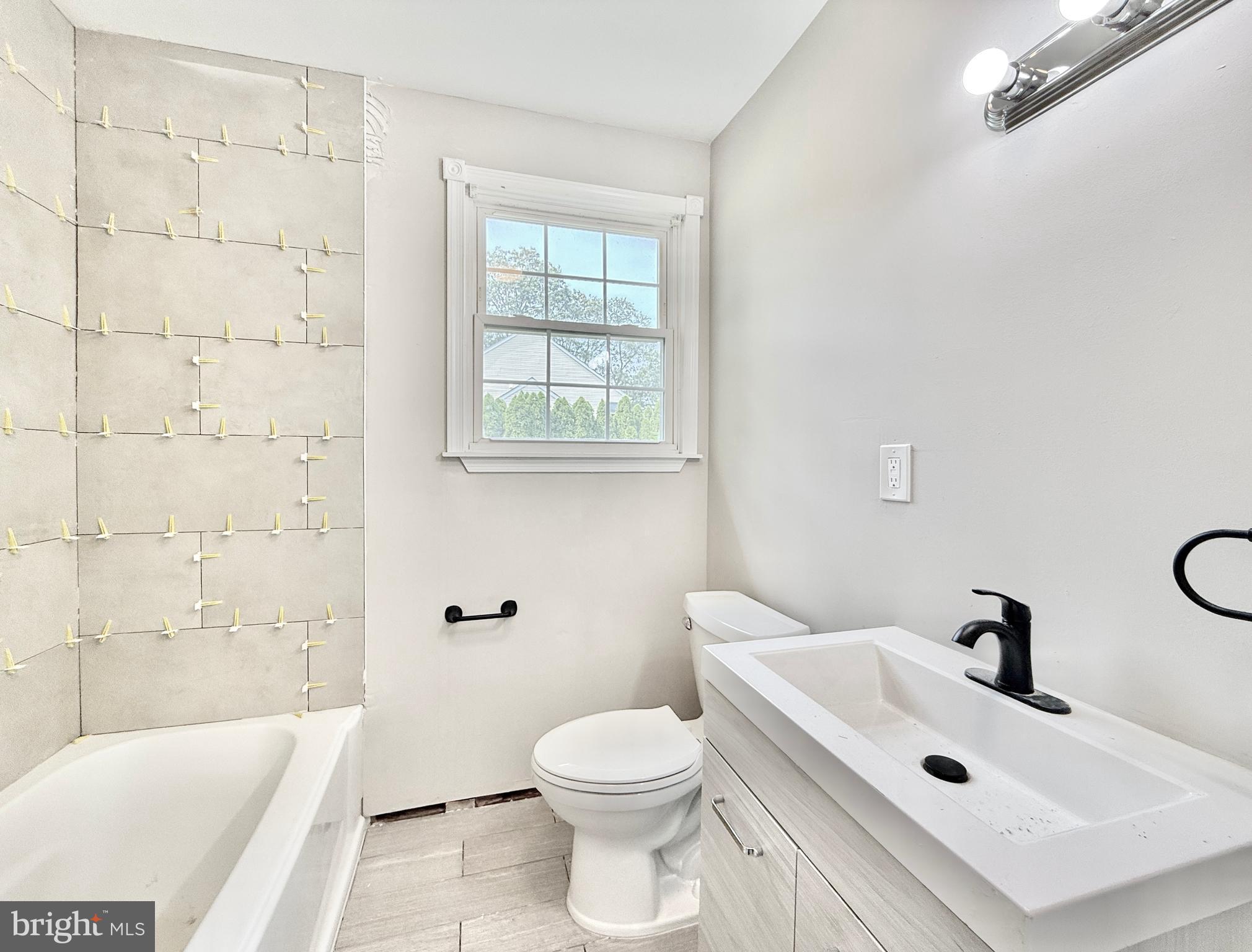 1097 Dutch Mill Road Newfield, NJ 08344 - Photo 19 of 23 a bathroom with a sink a toilet and shower