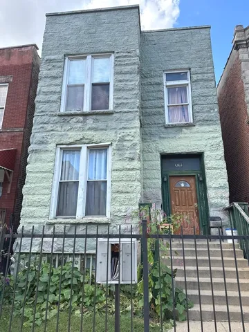 a brick building with a small yard