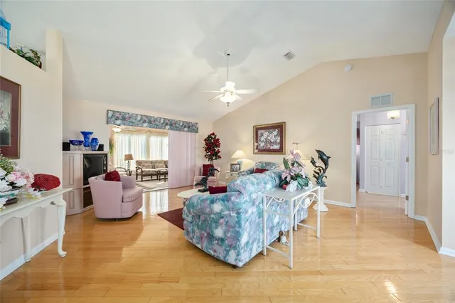 a living room with furniture and a chandelier