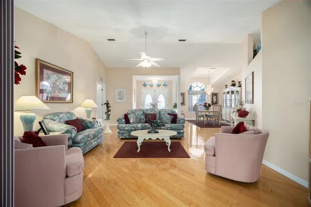 a living room with furniture and a chandelier