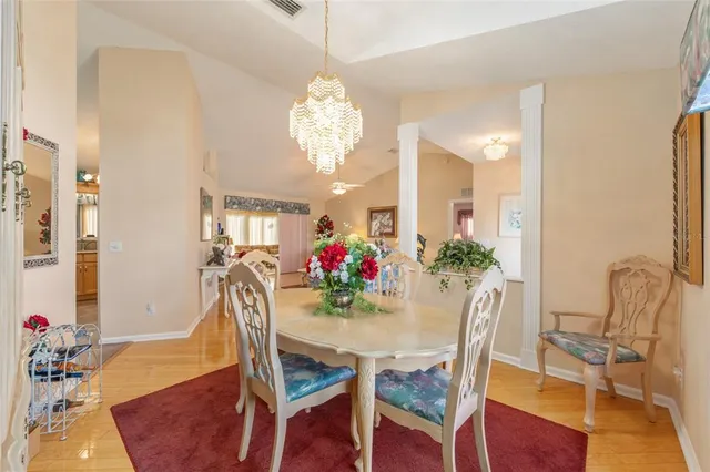 a view of a dining room with furniture and chandelier