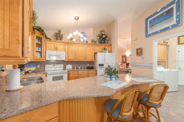 a kitchen with stainless steel appliances granite countertop a sink and cabinets