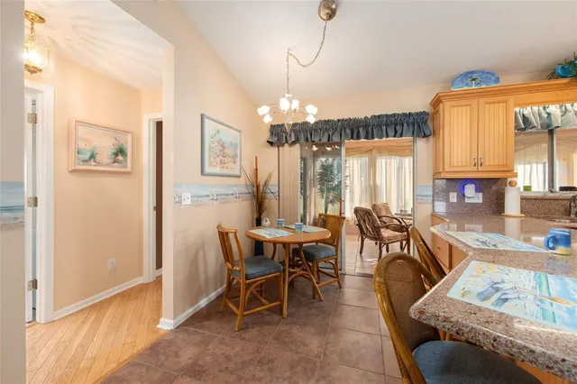 a view of a dining room with furniture and chandelier