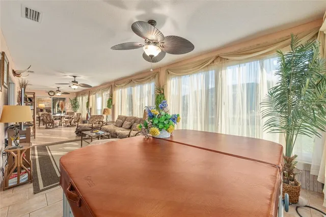 a spacious bedroom with a bed and a chandelier