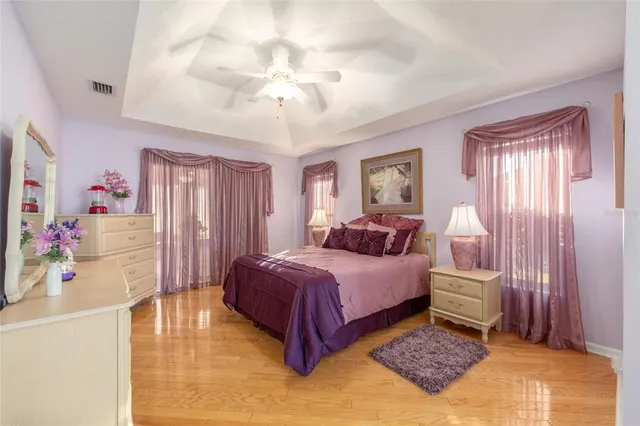 a spacious bedroom with a bed and a chandelier