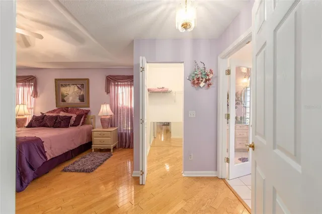 a bedroom with a large bed and a chandelier