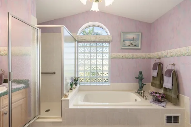 a living room with furniture a flat screen tv and a floor to ceiling window