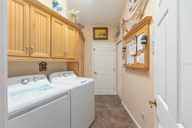 an aerial view of residential houses with outdoor space and parking