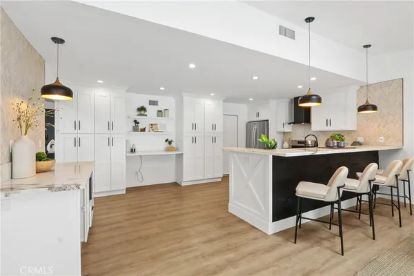 a living room with kitchen island furniture and a chandelier