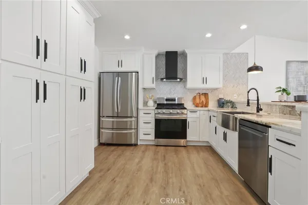 a kitchen with stainless steel appliances a refrigerator stove and sink