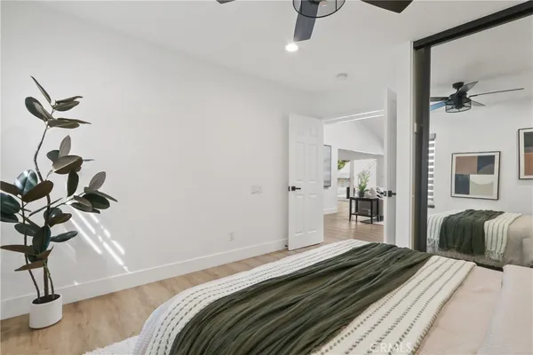 a bedroom with a bed and wooden floor