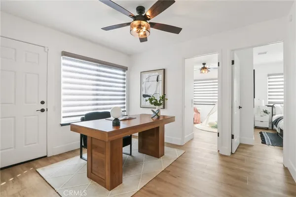 a dining room with wooden floor and a window