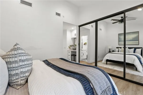 a bedroom with a bed and wooden floor