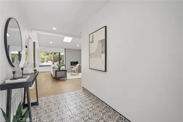 a living room with furniture and a mirror