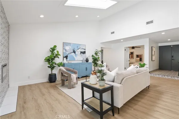 a living room with furniture and a potted plant