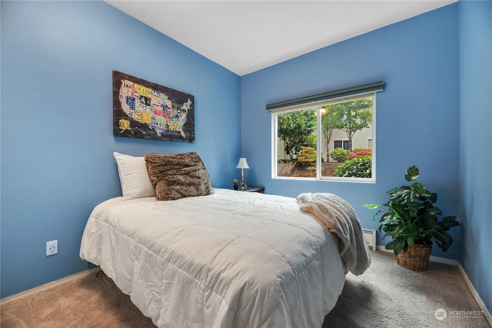 17604 134th Lane Southeast, Unit 17604 Renton, WA 98058 - Photo 13 of 25 a large bed sitting in a bedroom next to a window