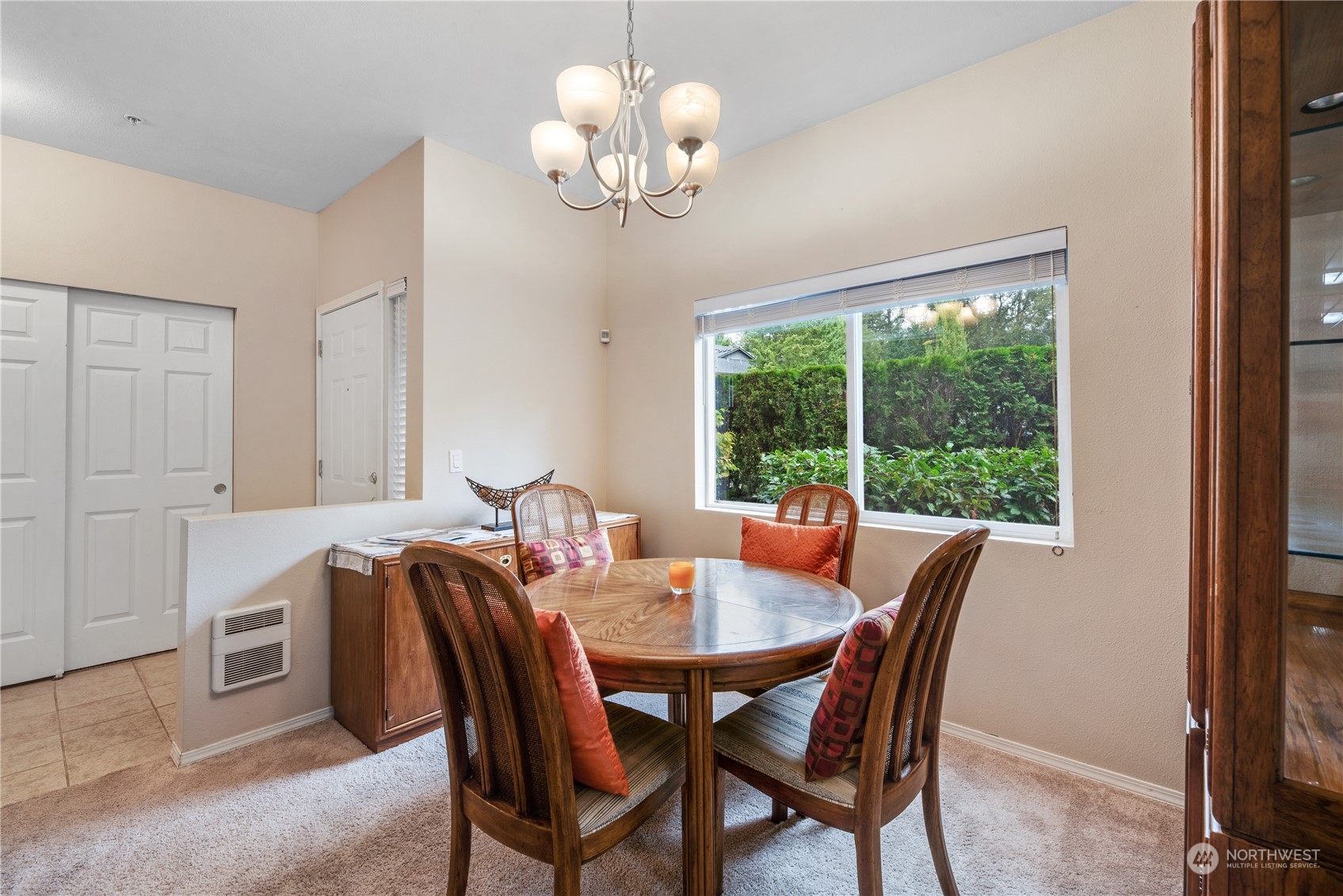 17604 134th Lane Southeast, Unit 17604 Renton, WA 98058 - Photo 4 of 25 a dining room with furniture a large window and a chandelier