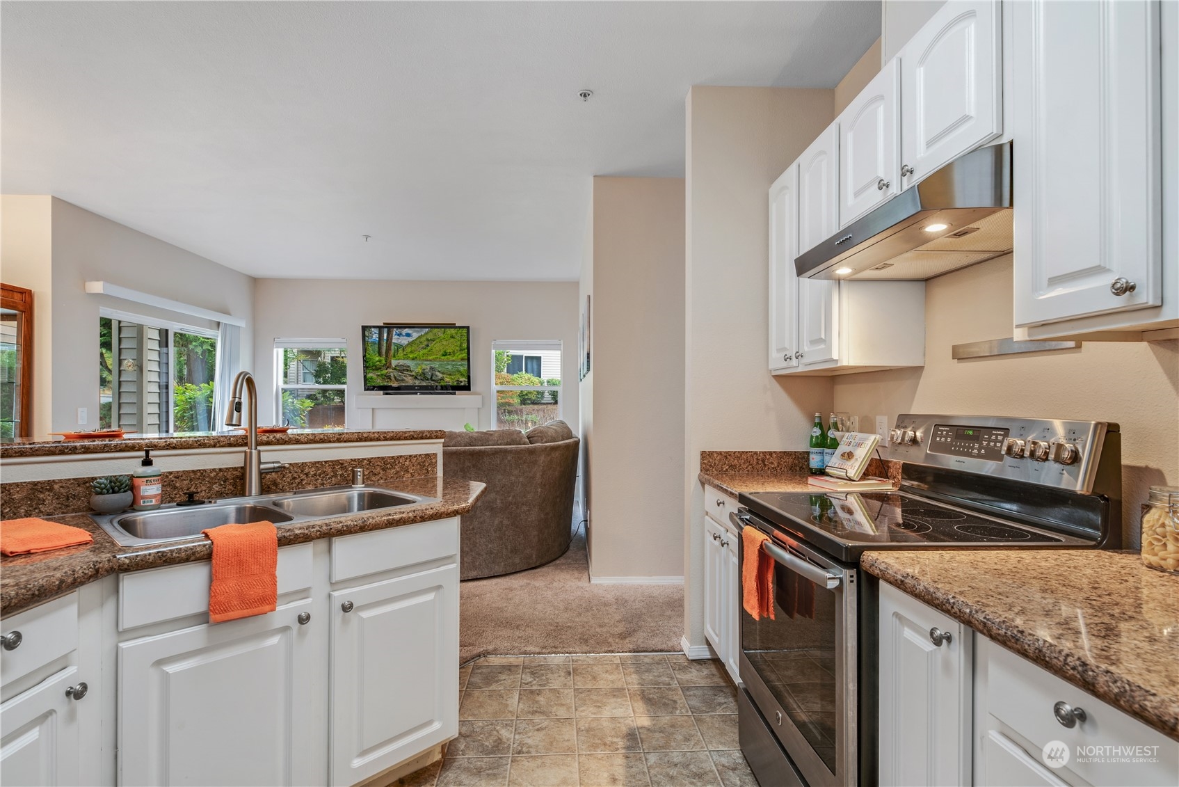17604 134th Lane Southeast, Unit 17604 Renton, WA 98058 - Photo 7 of 25 a kitchen with stainless steel appliances granite countertop a sink stove and cabinets
