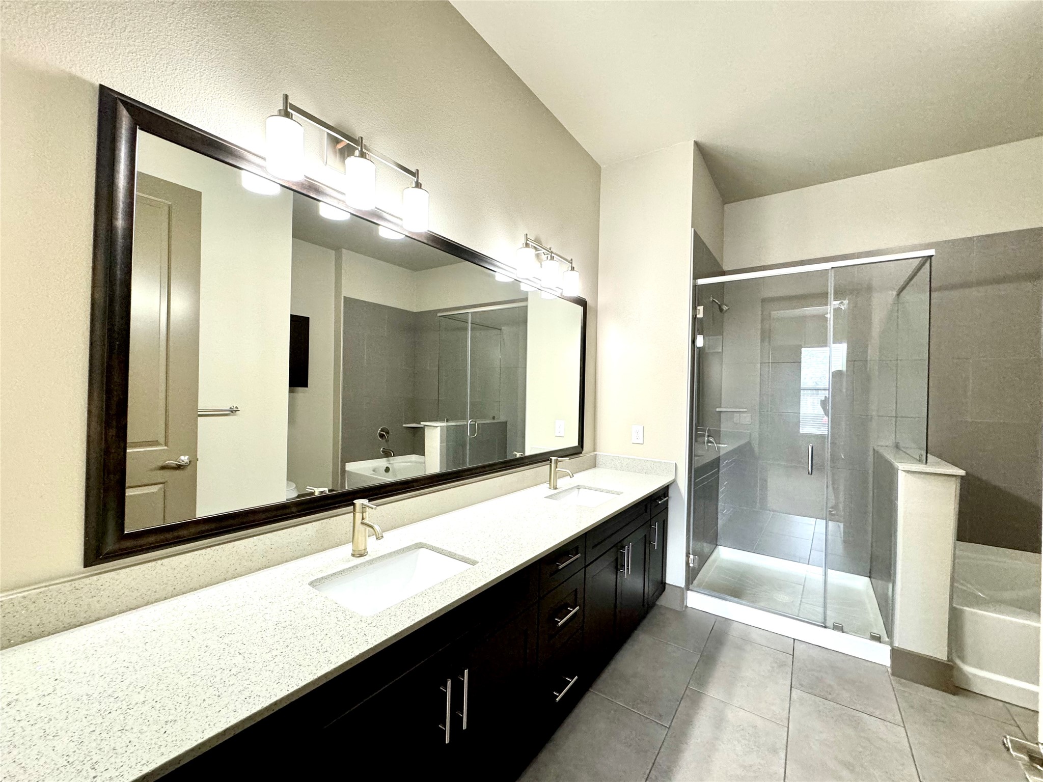 2033 South Gessner Road, Unit 2108 Houston, TX 77063 - Photo 9 of 21 a bathroom with a double vanity sink and a mirror