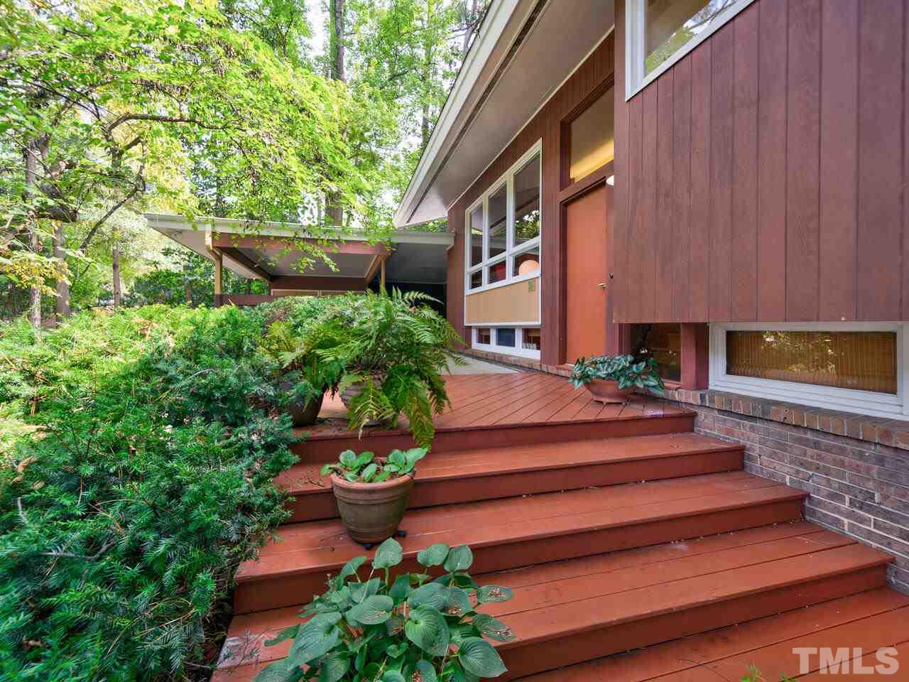 4512 Bartlett Street Raleigh, NC 27609 - Photo 21 of 30 The deck extends from the carport to around the back of the house