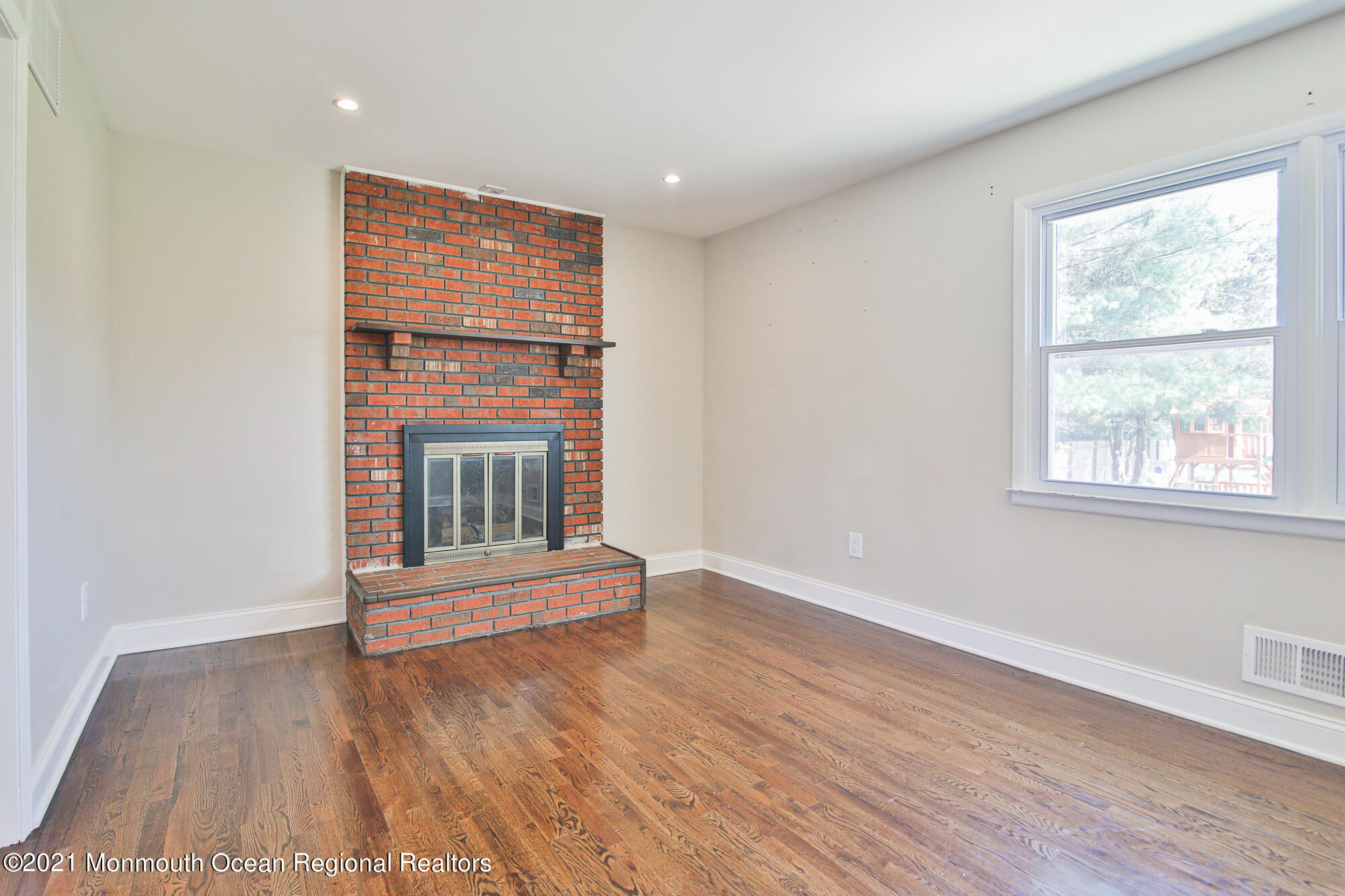 525 Frank Applegate Road Jackson, NJ 08527 - Photo 11 of 56 an empty room with wooden floor and windows