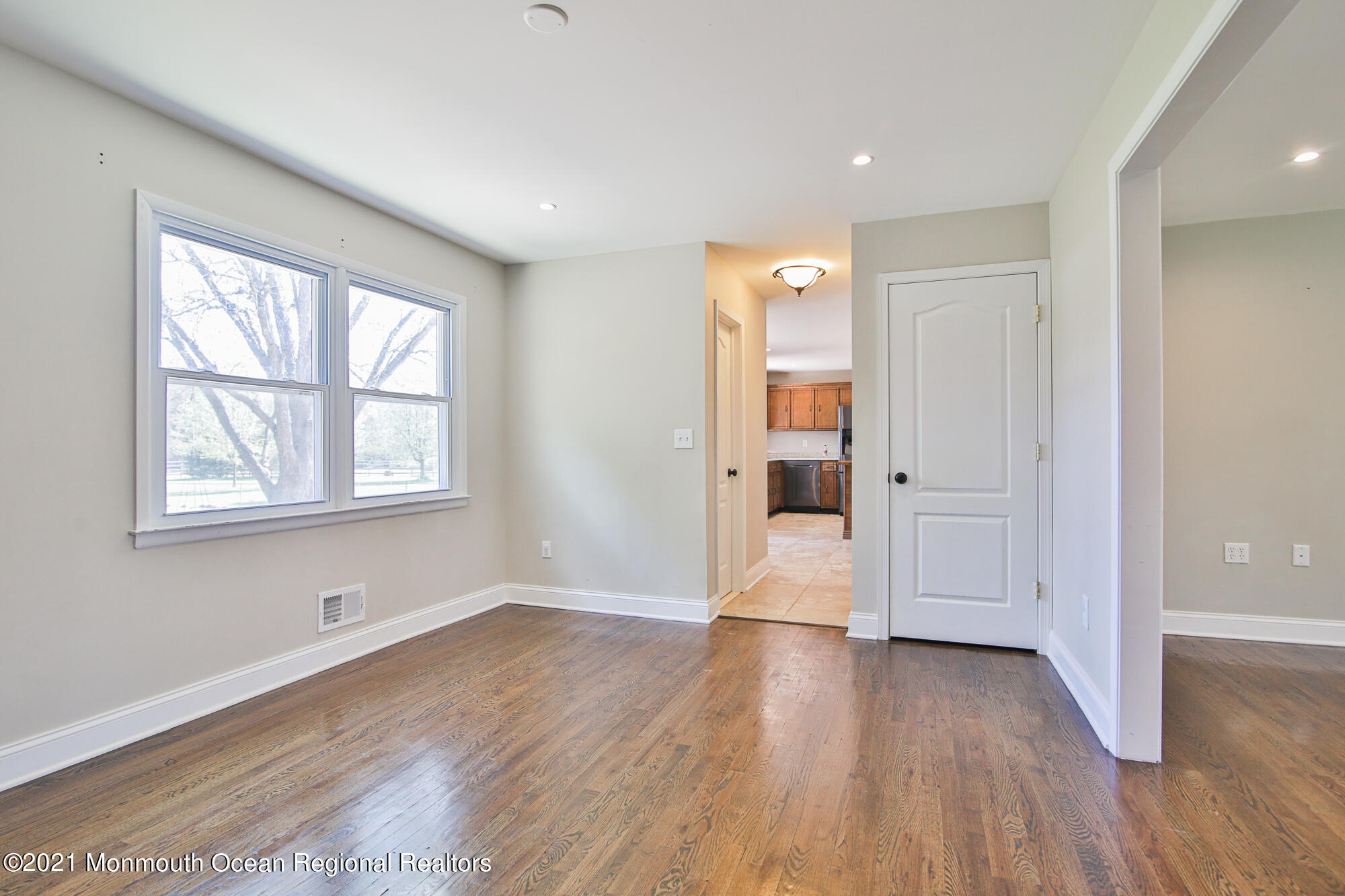 525 Frank Applegate Road Jackson, NJ 08527 - Photo 12 of 56 an empty room with wooden floor and windows