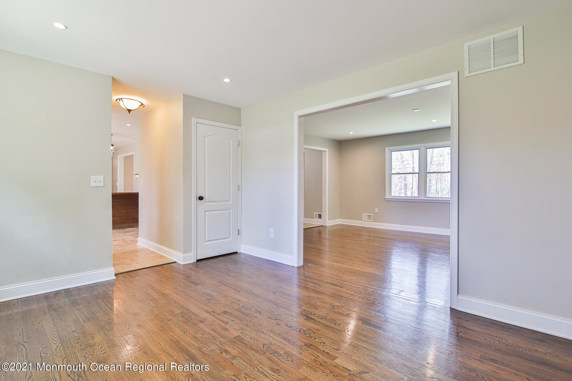 525 Frank Applegate Road Jackson, NJ 08527 - Photo 13 of 56 an empty room with wooden floor and windows