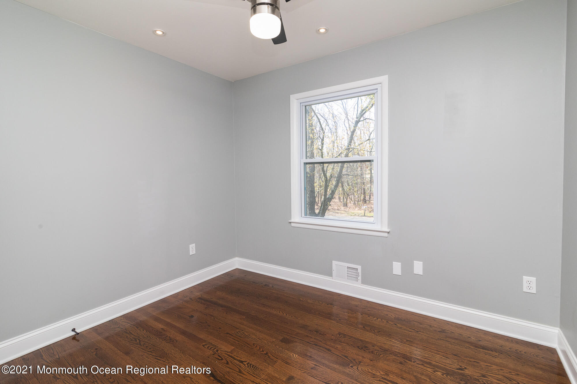 525 Frank Applegate Road Jackson, NJ 08527 - Photo 22 of 56 an empty room with wooden floor and windows