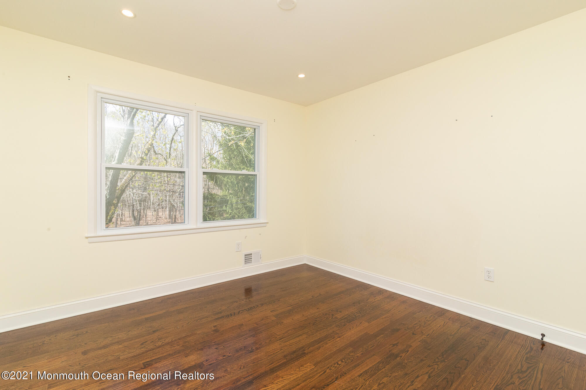525 Frank Applegate Road Jackson, NJ 08527 - Photo 25 of 56 an empty room with wooden floor and windows