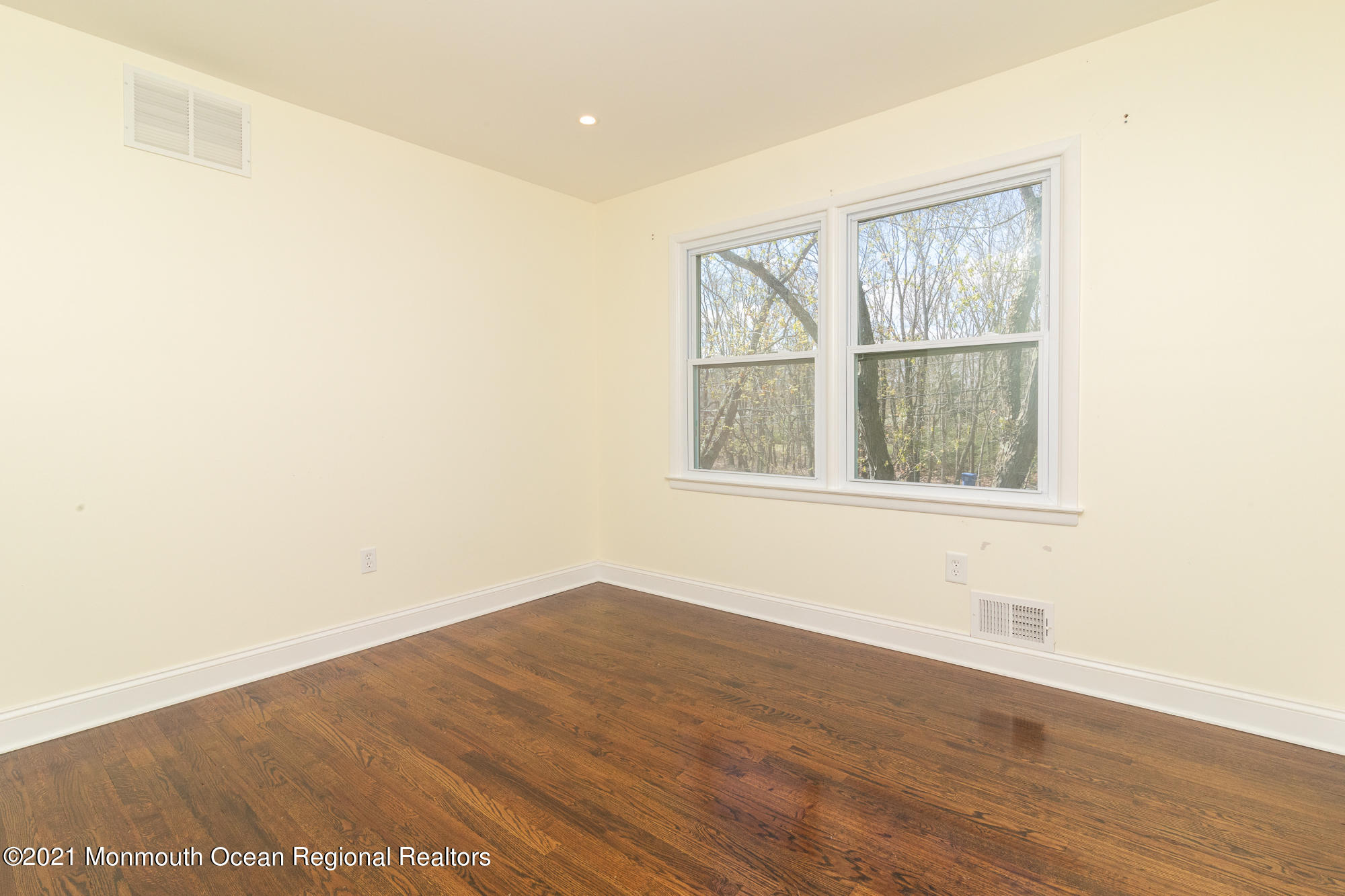 525 Frank Applegate Road Jackson, NJ 08527 - Photo 27 of 56 a view of an empty room with wooden floor and a window
