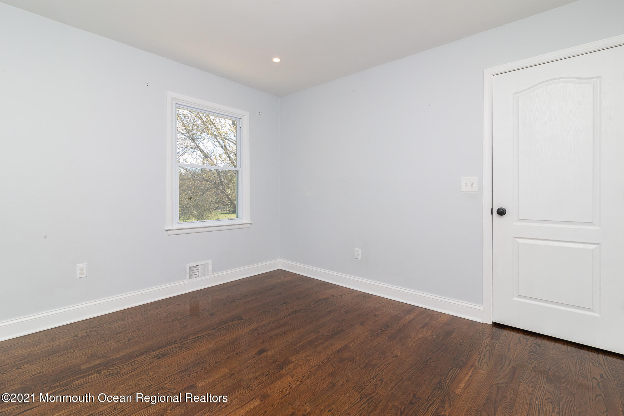 525 Frank Applegate Road Jackson, NJ 08527 - Photo 28 of 56 an empty room with wooden floor and windows