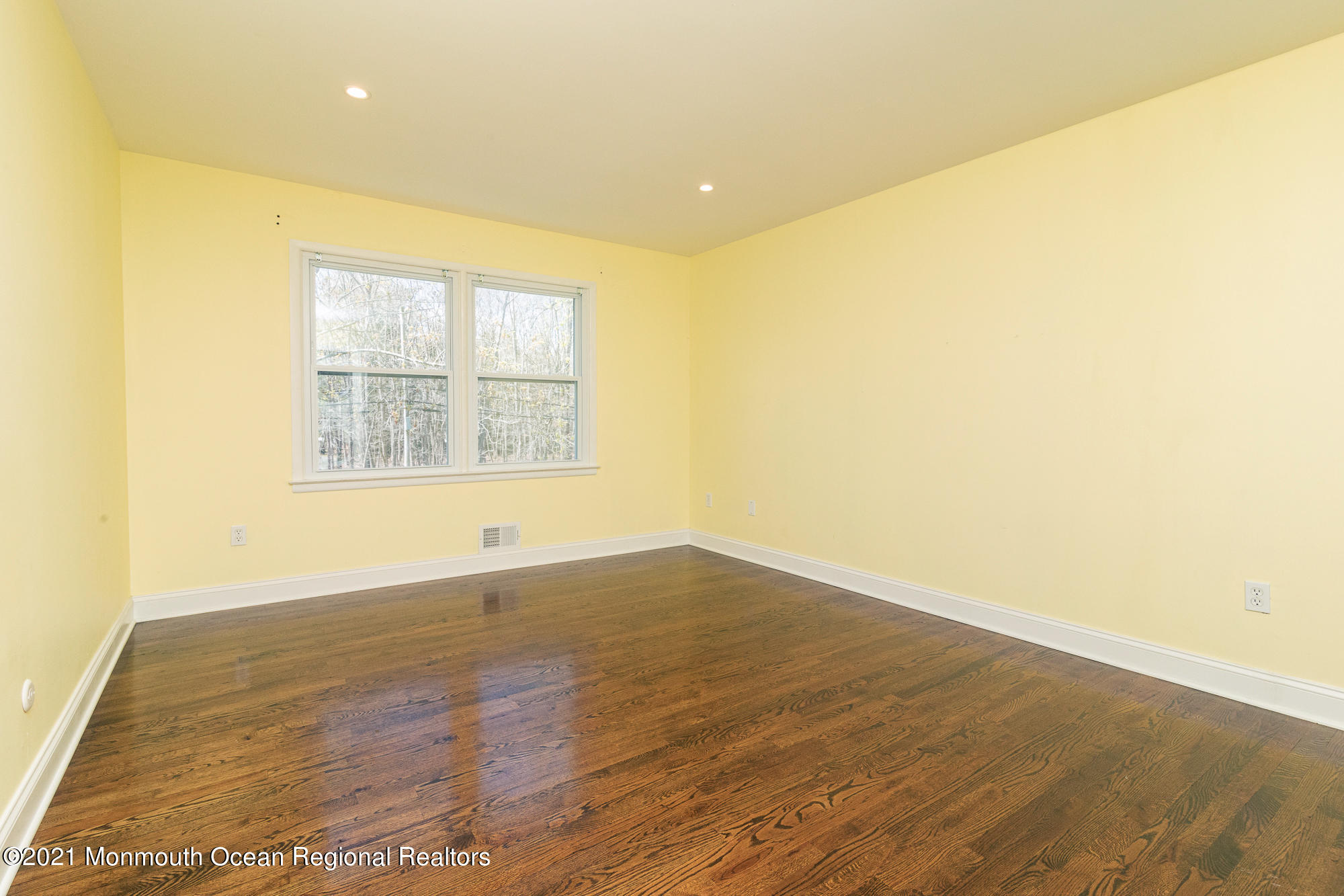 525 Frank Applegate Road Jackson, NJ 08527 - Photo 31 of 56 an empty room with wooden floor and windows