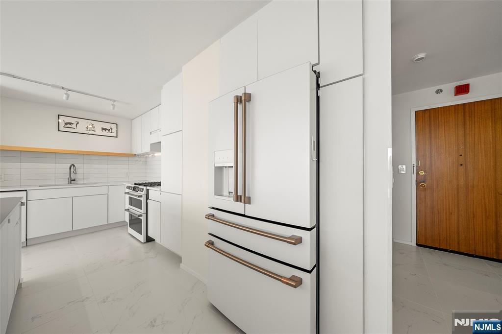 200 Old Palisade Road, Unit 25D Fort Lee, NJ 07024 - Photo 14 of 30 a view of a kitchen with white cabinets and white appliances