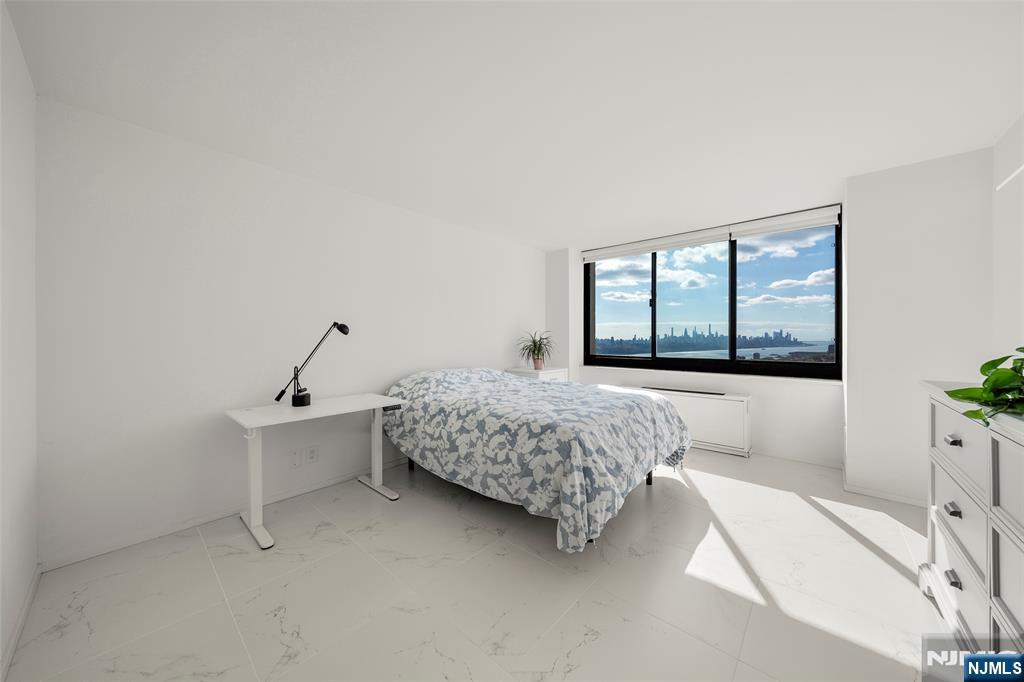200 Old Palisade Road, Unit 25D Fort Lee, NJ 07024 - Photo 18 of 30 a bedroom with a bed and window