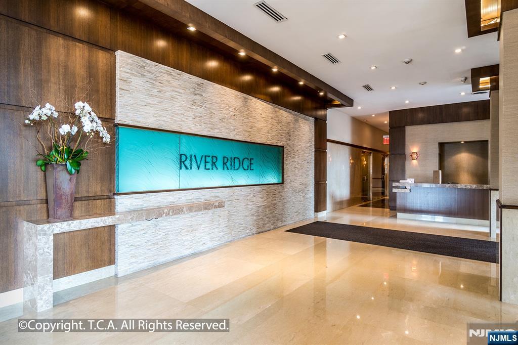200 Old Palisade Road, Unit 25D Fort Lee, NJ 07024 - Photo 25 of 30 a view of a hallway with a couch and a potted plant