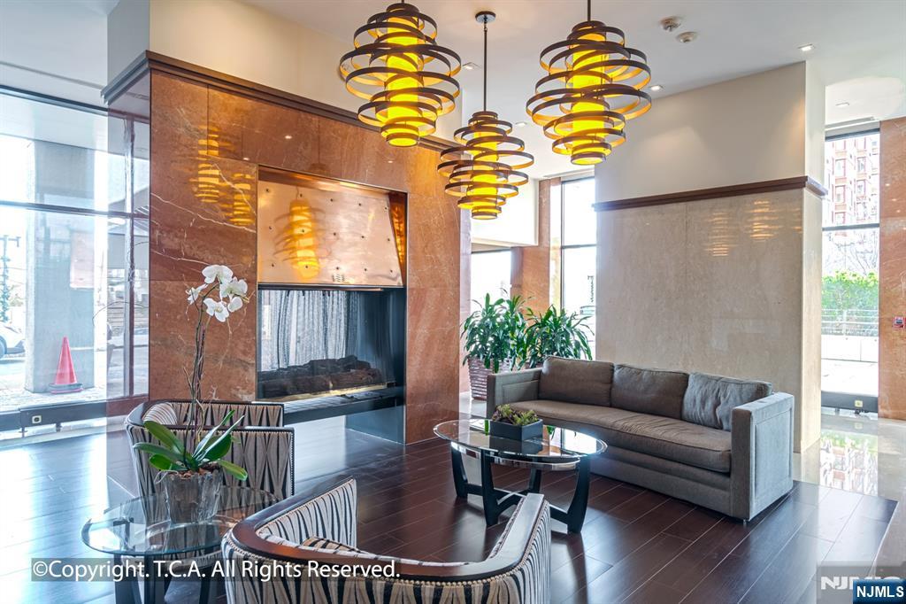 200 Old Palisade Road, Unit 25D Fort Lee, NJ 07024 - Photo 27 of 30 a living room with furniture and wooden floor