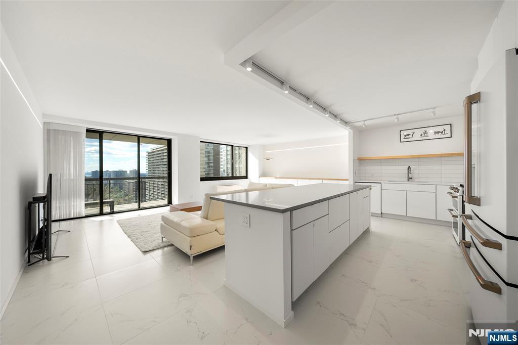 200 Old Palisade Road, Unit 25D Fort Lee, NJ 07024 - Photo 3 of 30 a large white room with a large window and couch