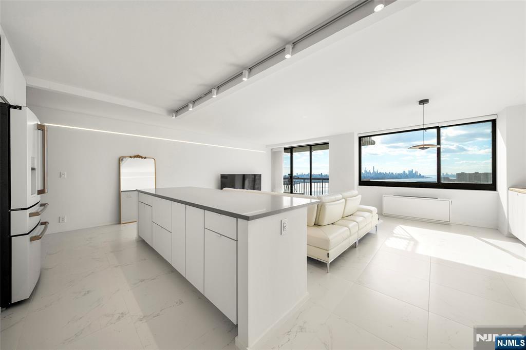 200 Old Palisade Road, Unit 25D Fort Lee, NJ 07024 - Photo 6 of 30 a living room with furniture and a large window