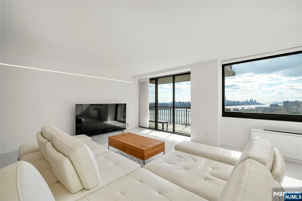 200 Old Palisade Road, Unit 25D Fort Lee, NJ 07024 - Photo 8 of 30 a living room with furniture and a large window